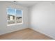 Bright bedroom with large window and contemporary light-colored hardwood floors at 6153 N Ceylon St # 307, Denver, CO 80249
