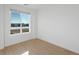 Bright bedroom featuring large window with neighborhood views and natural light at 6153 N Ceylon St # 307, Denver, CO 80249