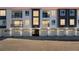 Modern townhome complex featuring individual garages and private balconies at 6153 N Ceylon St # 307, Denver, CO 80249