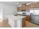 Modern kitchen featuring stainless steel appliances, quartz countertop, and island at 6153 N Ceylon St # 307, Denver, CO 80249