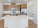 Modern kitchen with stainless steel appliances and a large center island featuring a white countertop at 6153 N Ceylon St # 307, Denver, CO 80249