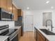 Kitchen with stainless steel appliances and wooden cabinets, and white countertops at 6153 N Ceylon St # 307, Denver, CO 80249