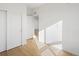 Bright living room with light hardwood floors and white walls at 6153 N Ceylon St # 307, Denver, CO 80249