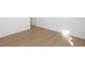 Empty room with light wood flooring and white walls at 6153 N Ceylon St # 307, Denver, CO 80249