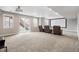Finished basement with carpeted flooring, theater seating, and a projector screen for entertainment at 16227 Pikes Peak Dr, Broomfield, CO 80023