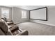 Finished basement with a theater seating area, projector screen, carpeted flooring and natural light at 16227 Pikes Peak Dr, Broomfield, CO 80023