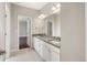Bathroom featuring double vanity, large mirrors, and modern fixtures and finishes at 16227 Pikes Peak Dr, Broomfield, CO 80023
