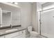 Modern bathroom featuring a tiled shower, a toilet, and a gray vanity with a white basin sink at 16227 Pikes Peak Dr, Broomfield, CO 80023