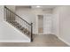 Inviting entryway with staircase, neutral color palette, and entry to additional room at 16227 Pikes Peak Dr, Broomfield, CO 80023