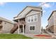 Rear view of home showcasing a deck and well-maintained lawn at 16227 Pikes Peak Dr, Broomfield, CO 80023