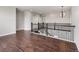 Upstairs hallway with iron railing overlooking the staircase, recessed lighting, and hardwood floors at 16227 Pikes Peak Dr, Broomfield, CO 80023