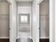 Hallway view to the bathroom showcasing a tub and lots of bright, natural light at 16227 Pikes Peak Dr, Broomfield, CO 80023