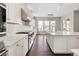 Long and bright kitchen with stainless steel appliances and white cabinets and countertops at 16227 Pikes Peak Dr, Broomfield, CO 80023