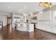 Spacious gourmet kitchen with white cabinetry, stainless appliances and large island with seating at 16227 Pikes Peak Dr, Broomfield, CO 80023
