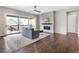 Bright living room boasts a modern fireplace, hardwood floors, and sliding glass doors to a balcony at 16227 Pikes Peak Dr, Broomfield, CO 80023