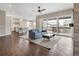 Open concept living area adjacent to kitchen with hardwood floors and access to the backyard deck at 16227 Pikes Peak Dr, Broomfield, CO 80023