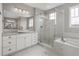A luxurious main bathroom features a glass shower, soaking tub and double vanity sinks at 16227 Pikes Peak Dr, Broomfield, CO 80023