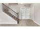 Carpeted staircase with decorative metal railing leading to additional living space, next to a storage closet at 16227 Pikes Peak Dr, Broomfield, CO 80023