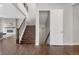 View of the home's wooden staircase and hardwood flooring, leading to an open basement at 16227 Pikes Peak Dr, Broomfield, CO 80023