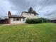 Large backyard with green lawn and partial view of the home's exterior at 9062 Utica St, Westminster, CO 80031