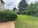 Spacious backyard with lush green grass and mature trees at 9062 Utica St, Westminster, CO 80031