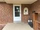 Traditional brick facade with white front door and decorative alcove for address number at 9062 Utica St, Westminster, CO 80031