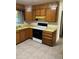 Traditional kitchen with wood cabinets, neutral countertops, and a black and white stove at 9062 Utica St, Westminster, CO 80031
