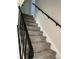 Carpeted stairway with black metal railing leading to the upper level of the home at 9062 Utica St, Westminster, CO 80031