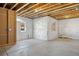 Unfinished basement featuring insulated walls, concrete floors, and a door to the outside at 10723 N Montane Dr, Broomfield, CO 80021