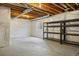 Unfinished basement with insulated walls, concrete floor and metal storage shelving at 10723 N Montane Dr, Broomfield, CO 80021