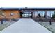 Clubhouse entrance with large glass windows, stone accents, prominent address, and a well-maintained walkway at 10723 N Montane Dr, Broomfield, CO 80021