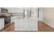 Kitchen island with marble countertop and stainless steel appliances creates a chef-friendly space at 10723 N Montane Dr, Broomfield, CO 80021