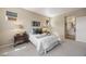 Inviting main bedroom featuring soft carpeting, neutral decor, and an ensuite bathroom at 10723 N Montane Dr, Broomfield, CO 80021