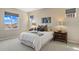Comfortable main bedroom featuring neutral tones, large windows, and stylish decor at 10723 N Montane Dr, Broomfield, CO 80021
