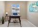 Home office with a dark wood desk, blue chair, and a window with natural light at 10723 N Montane Dr, Broomfield, CO 80021