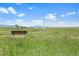 Scenic view of community green space featuring a bench, trail, and distant mountain views at 10723 N Montane Dr, Broomfield, CO 80021