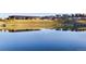 Scenic view of a tranquil pond reflecting the community clubhouse and surrounding landscape at 10723 N Montane Dr, Broomfield, CO 80021