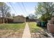 View of a backyard with a house, fence, and utility bins at 1148 N Clinton St, Aurora, CO 80010