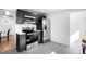 Well-lit kitchen featuring updated stainless steel appliances and gray tile floors at 1148 N Clinton St, Aurora, CO 80010
