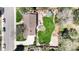 An aerial view shows a well-maintained property with a spacious lawn and patio at 3850 S Willow Way, Denver, CO 80237