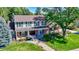 Charming two-story home with manicured lawn, mature trees, and inviting front porch creating curb appeal at 3850 S Willow Way, Denver, CO 80237
