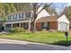 Side view of home with attached garage and large manicured front lawn at 3850 S Willow Way, Denver, CO 80237