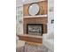 Living room fireplace with hearth, white mantel, brick facade, and decorative shelving at 3850 S Willow Way, Denver, CO 80237