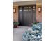 Elegant front door with sidelights, decorative glass, and brick facade creating a welcoming entrance at 3850 S Willow Way, Denver, CO 80237
