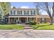 Charming two-story home with a well-manicured lawn, a brick facade, and inviting curb appeal at 3850 S Willow Way, Denver, CO 80237