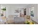 Cozy seating area with hardwood floors, decorative chairs, and an open view into the living area at 3850 S Willow Way, Denver, CO 80237