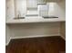 Kitchen with gray cabinets, white appliances, stainless steel sink, and an eat-in counter at 12450 E Cornell Ave # 101, Aurora, CO 80014