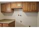 Laundry Room featuring oak cabinetry at 12450 E Cornell Ave # 101, Aurora, CO 80014