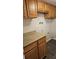 Laundry Room featuring oak cabinetry and hardwood floors at 12450 E Cornell Ave # 101, Aurora, CO 80014