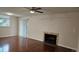 Bright living room featuring hardwood floors, a ceiling fan, and a cozy fireplace at 12450 E Cornell Ave # 101, Aurora, CO 80014